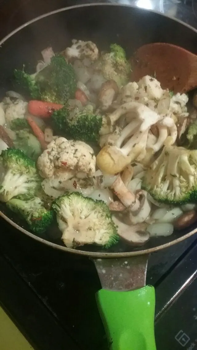 sauteeing up some broccoli,  cauliflower,  carrots,  and tons of mushrooms in butter and avocado oil.|Polly Gelfusoさん