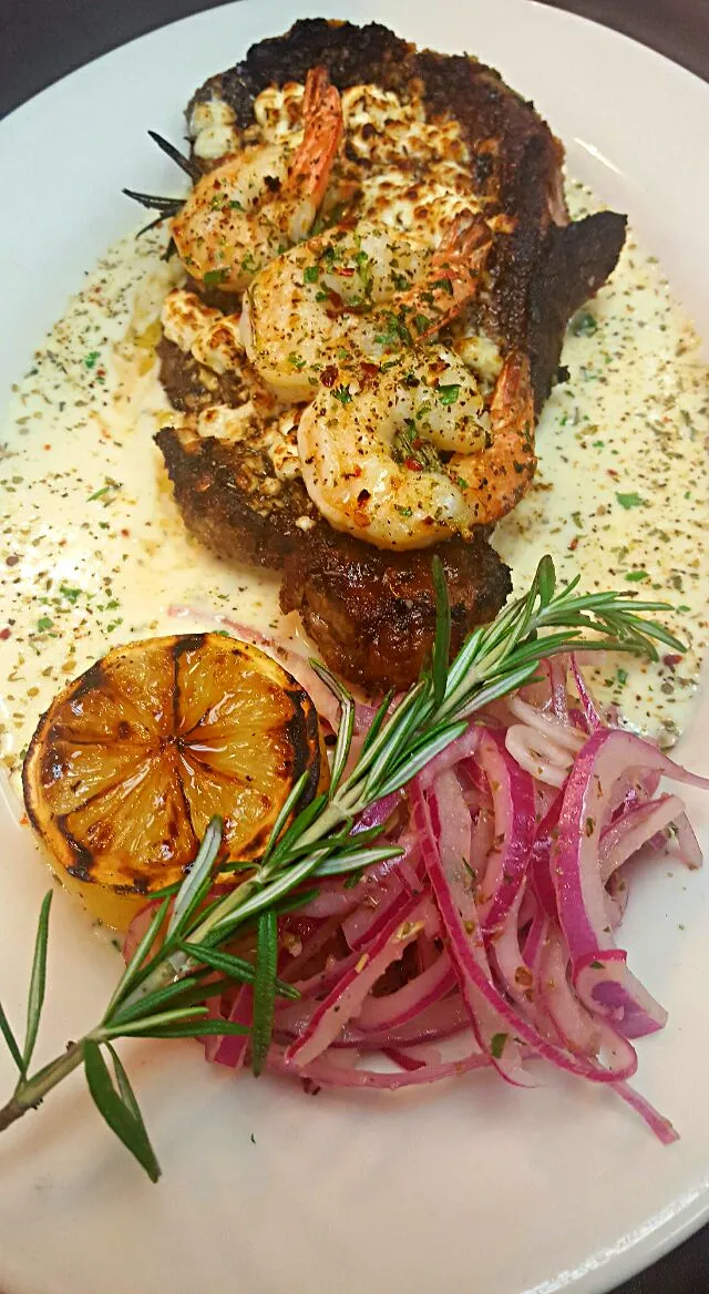 Greek style ribeye steak with rosemary skewered shrimp marinated onions atop a sauce of lemon ,roasted garlic and cream...|chef Charlesさん