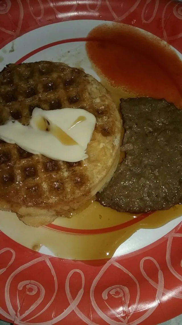 Snapdishの料理写真:ancient grains waffle with butter,  a gardien breakfast sausage patty,  with Vermont maple syrup and red hot.|Polly Gelfusoさん