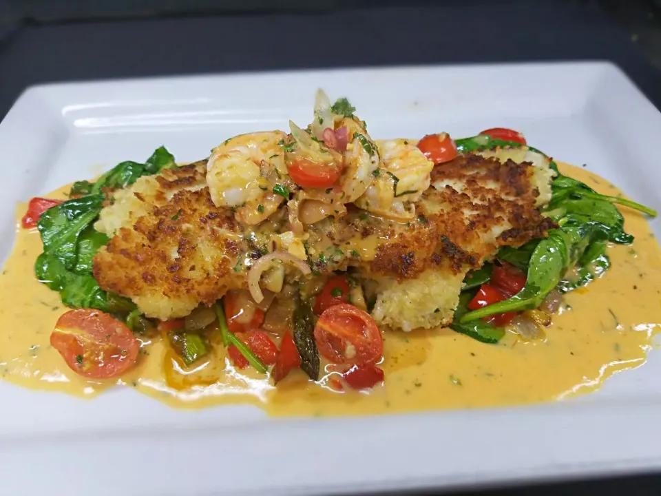 parmesan crusted flounder served over sauteed spinach and vegetables with a shrimp scampi and tomato basil butter sauce|Melissa Greenさん