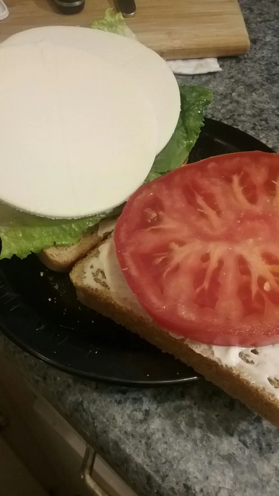 Snapdishの料理写真:lettuce,  tomato,  and provolone with mayo and salt on whole wheat bread.|Polly Gelfusoさん