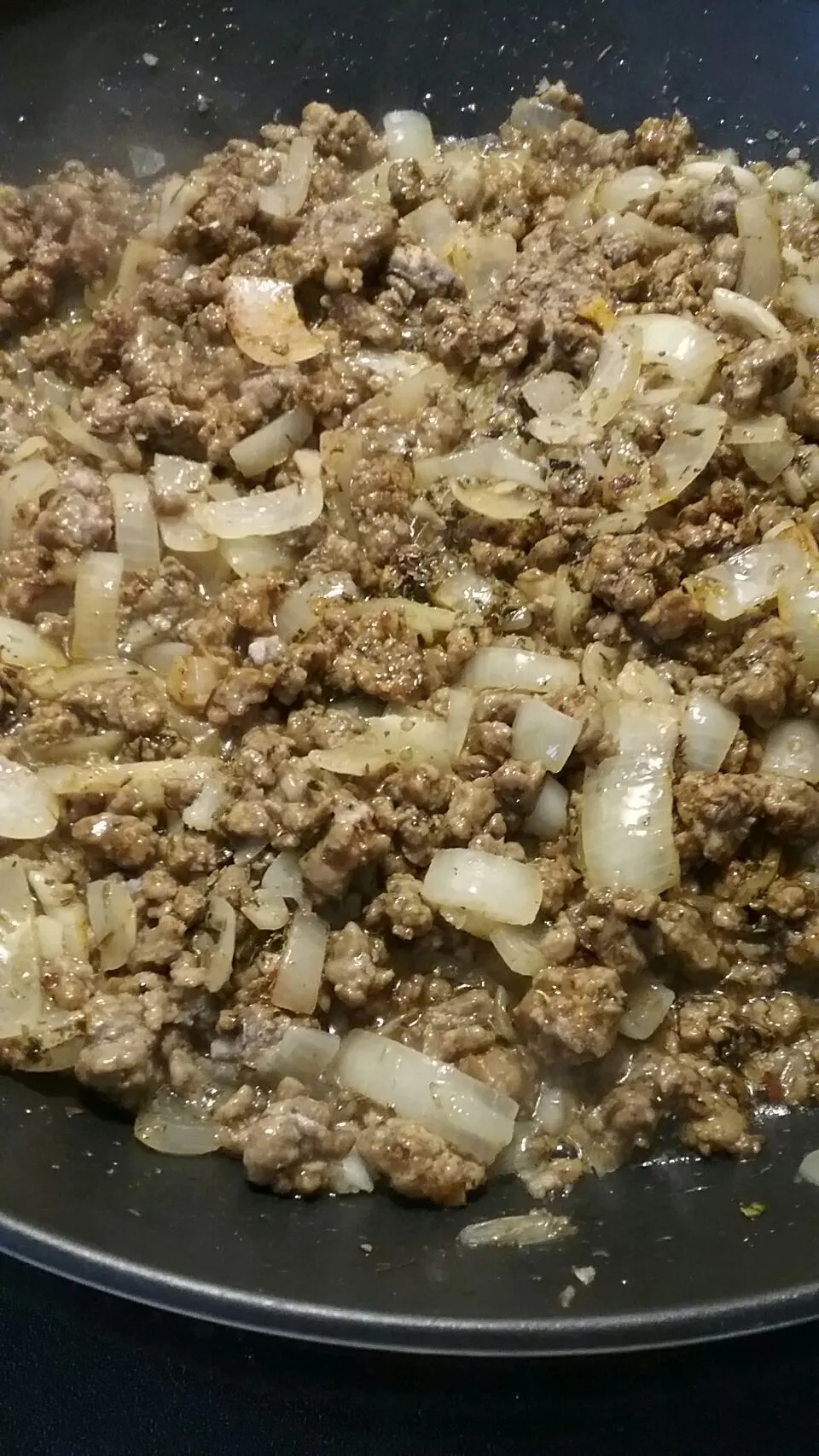 sauteeing beyond meat crumbles with onions and garlic for sauce.|Polly Gelfusoさん