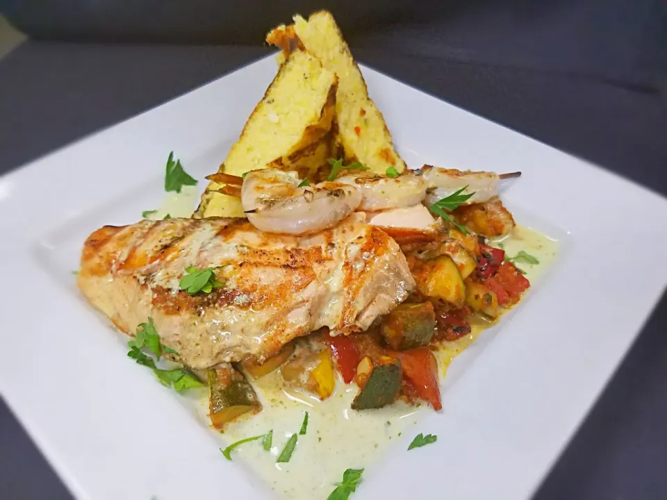 Mixed Grill. Atlantic salmon, wild-caught North Carolina Shrimp, grilled summer vegetable Ratatouille, with a parmesan polenta cake and basil butter.|Melissa Greenさん