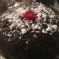 Chocolate cake with cocoa truffles inserted in the middle prior to baking. Once baked topped with a peanut butter sprinkle of powder sugar/|jeannette simmons jrさん