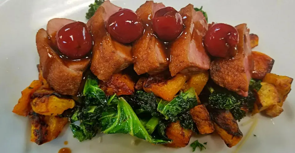 crispy duck over butternut squash and kale,topped with a cherry demi glace|chef Charlesさん