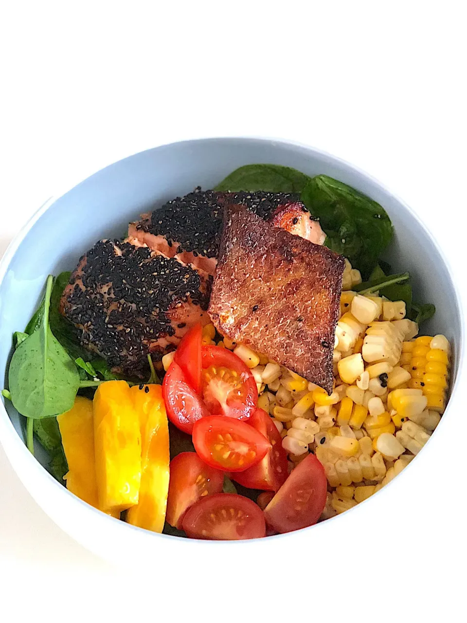 Snapdishの料理写真:Salmon bowl, sesame crusted salmon, crispy salmon skin, corn, tomato, mango, wafu dressing|12Dragonさん