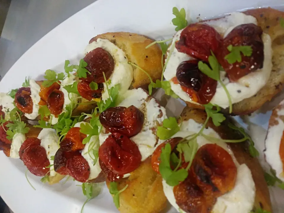 Snapdishの料理写真:Bruschetta..Topped with Whipped Ricotta, Roasted Tomatoes Seasoned with Fresh Herbs and Cracked Black Pepper|Crystal Carltonさん