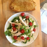 Snapdishの料理写真:My favorite lunch. Arugula, cherry tomatoes, scallions and rotisserie chicken. Also savoring this hunk of bread on the eve of a 30-day cleanse.|emilyDeSantoさん