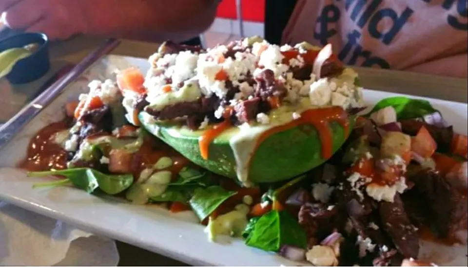 Avocado Stuffed with skirt steak top with feta cheese with spring salad and guava sauce |Frank Ortizさん