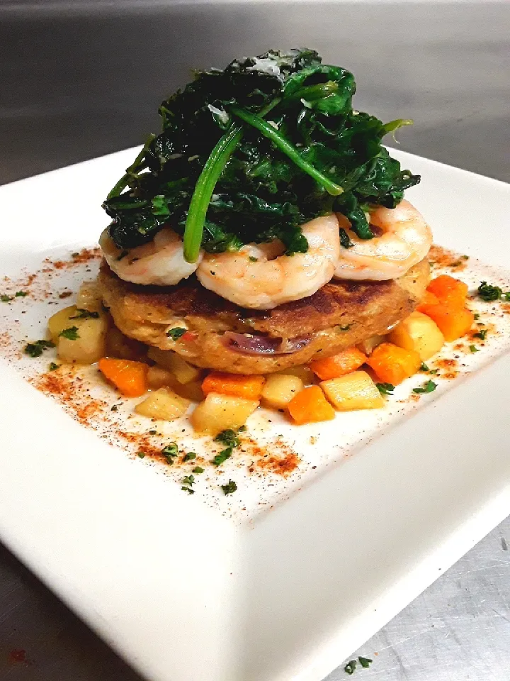 Crab Cake over Roasted Root Vegetables topped w/ Garlic Lemon Butter and Wine Sauteed Shrimp & Spinach|Hector Parraさん