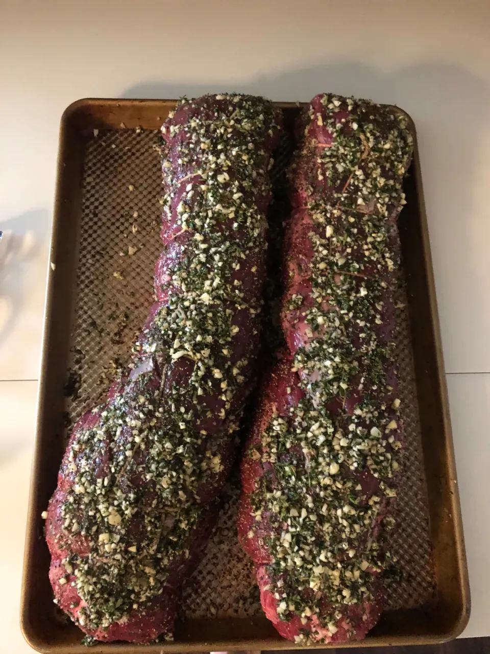 Two beef tenderloins marinating with garlic, rosemary and thyme.|ernest ristiさん