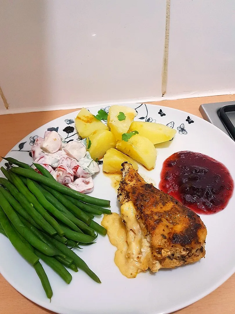 Grilled chicken breast stuffed with turkey bacon and swiss cheese. Served with 
steamed green beans, boiled potatoes, tomato radish salad and cranberry sauce .|For the love of foodさん