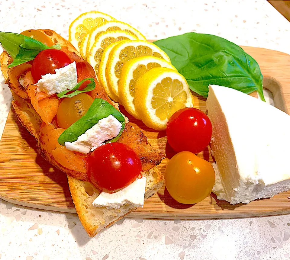 Snapdishの料理写真:French baguette pastrami smoked salmon with lemon, basil, queso fresco, heirloom baby tomatoes|🌺IAnneさん