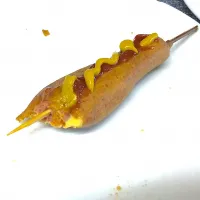 Corn dog with tomatoe ketchup and mustard with cheese filling.|saki90さん