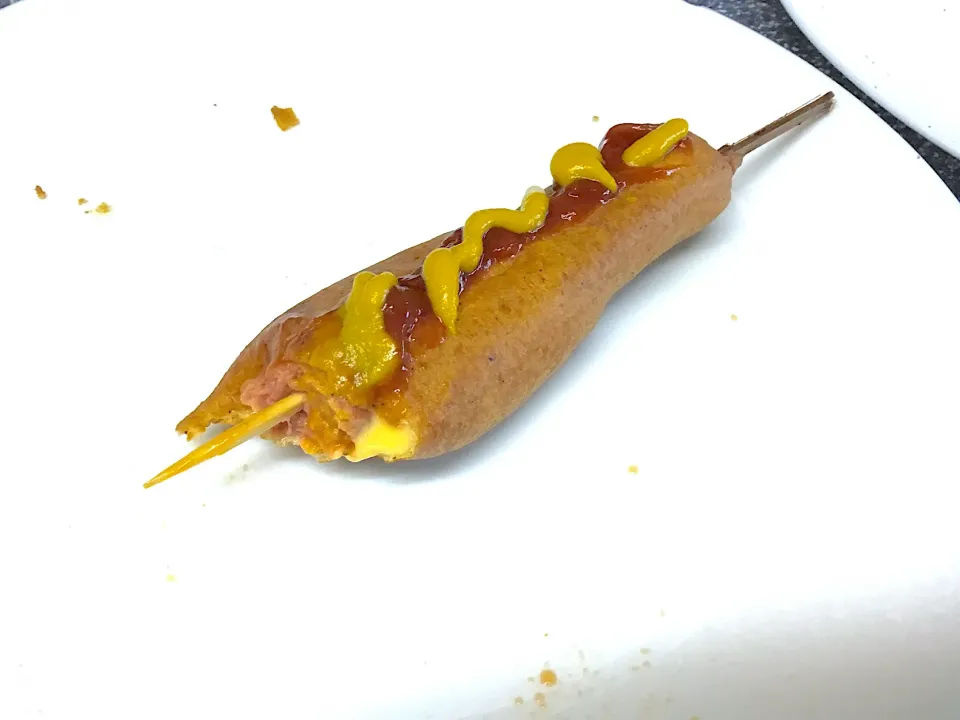 Corn dog with tomatoe ketchup and mustard with cheese filling.|saki90さん