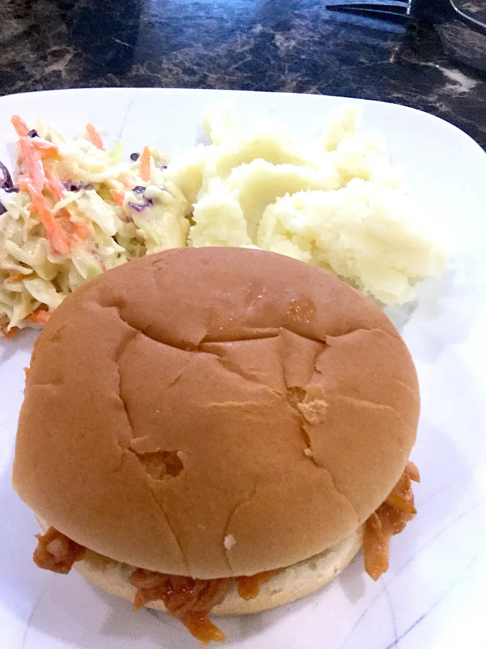 Pulled pork sandwich and a side of mashed potatoes and coleslaw|ninja kittyさん