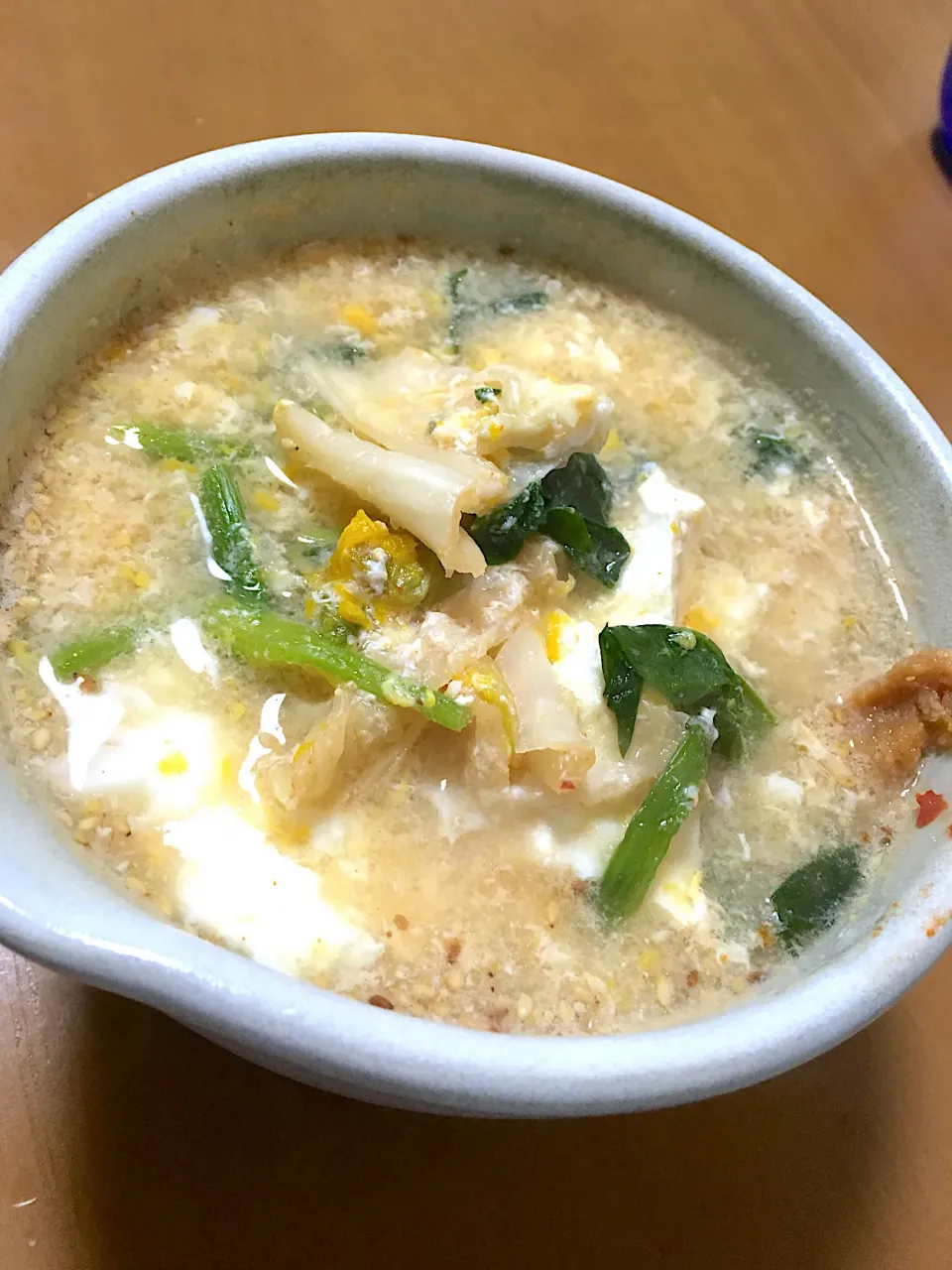 Snapdishの料理写真:朝ごはん、何でも入れて煮込んだ雑炊😋味噌と柚子胡椒を添えて。|さくたえさん