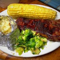 Michaels Culinary Adventures's dish Grilled NY Strip, Baked Potato, Corn & Brussel Sprouts