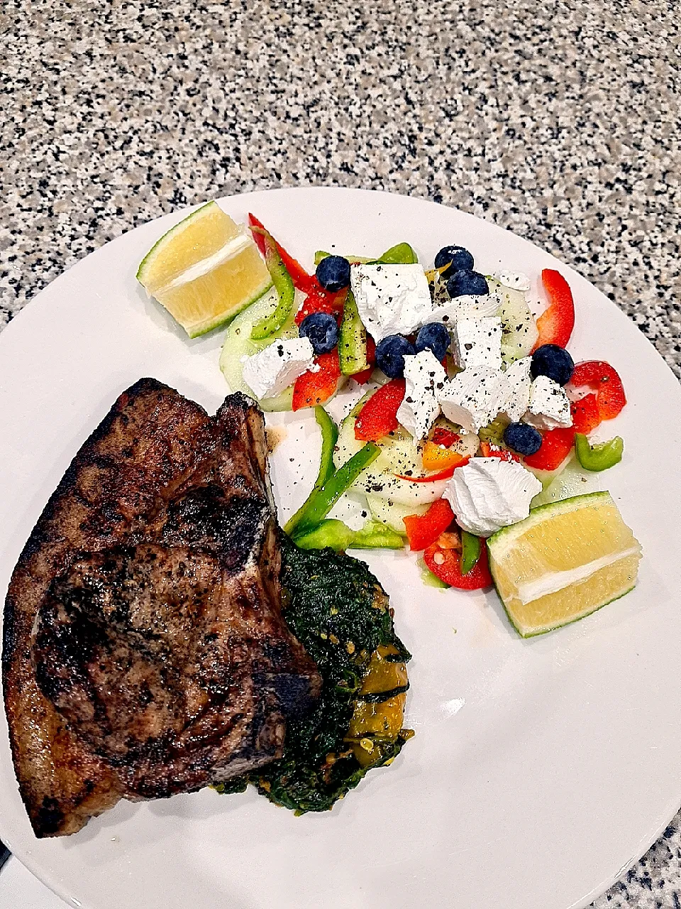 pork chops on a bed of spinach with salad|Just meさん