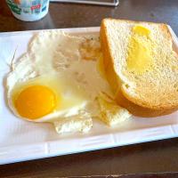 Two pan fried eggs and buttered toast