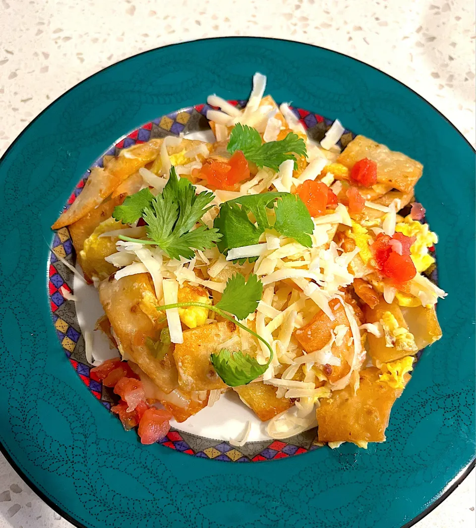 Chilaquiles - fried flour tortilla chips topped with sauteed scrambled eggs & cheese garnished with tomato salsa and cilantro|🌺IAnneさん