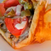 Snapdishの料理写真:my special made gyros   layer out on a crusty buttery flat bread fill with  slice lamb cover with  onion, pepper, tomatoes topped off with  special  gyros chees sauce with  added  mushrooms  and olives|Carolyn Sincere Marshallさん