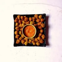 Snapdishの料理写真:moong dal pakode
(deep fried green lentil fritters)
with tomato chutney|spiceitupさん