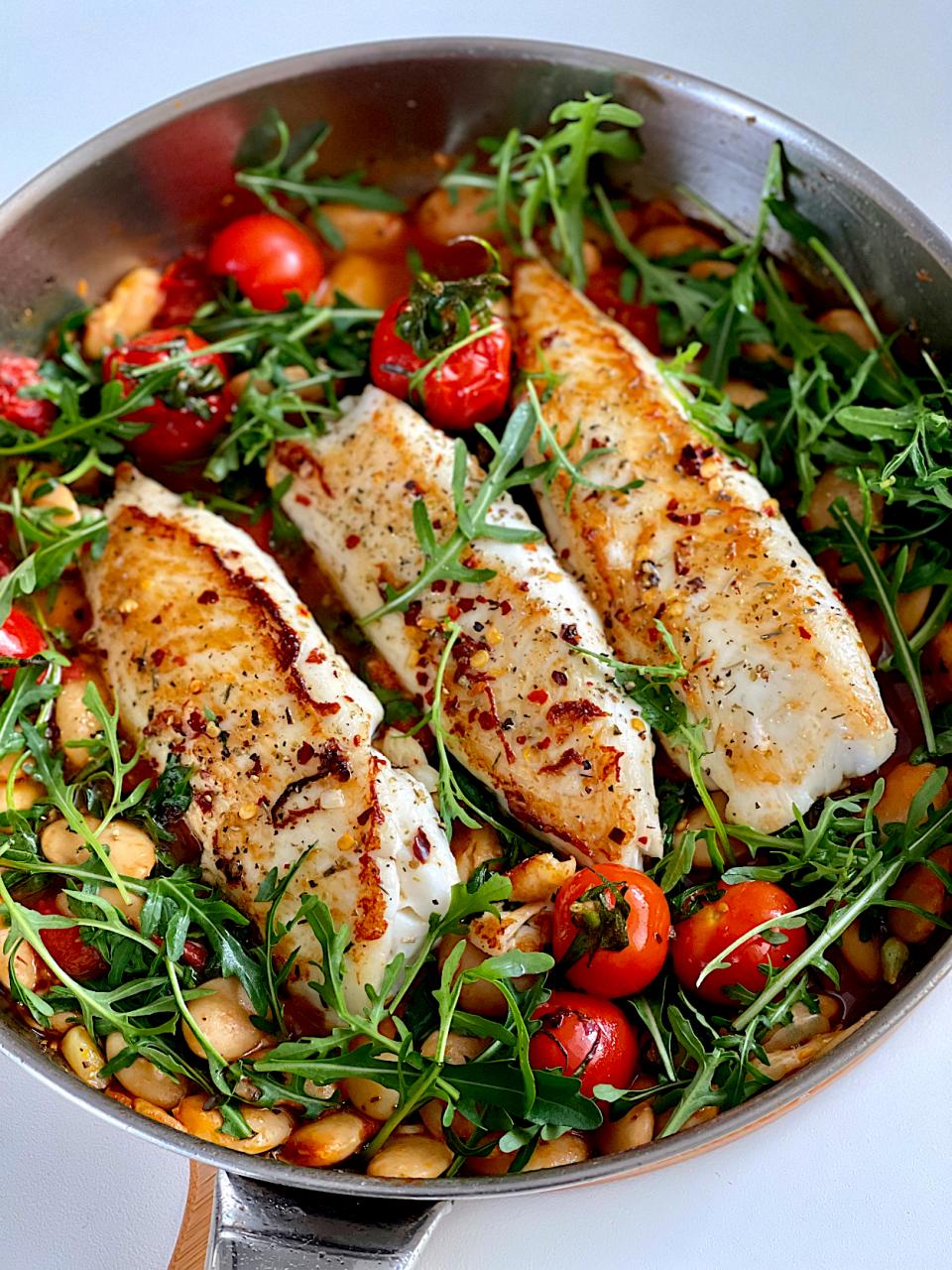 Pan fried fish, butter beans, tomatoes and wilted arugula