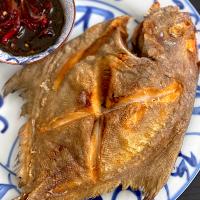 Crispy fried fish with onion sauce