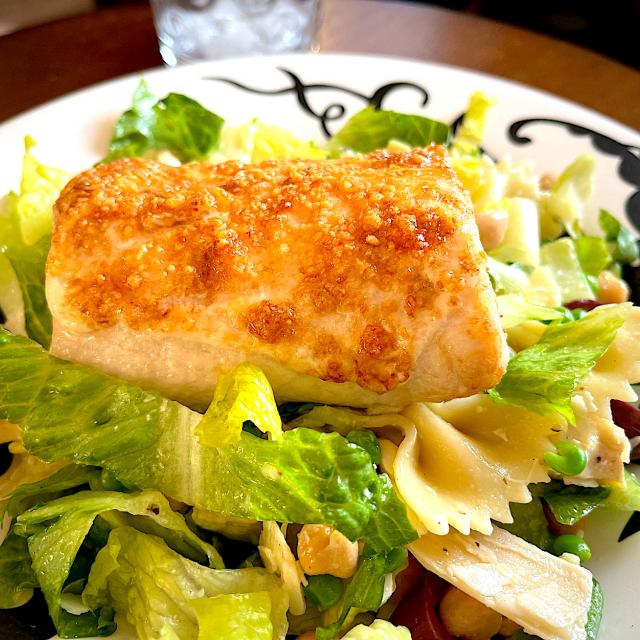 Parmesan and Romano crusted air fried mahi mahi on a bed of lettuce