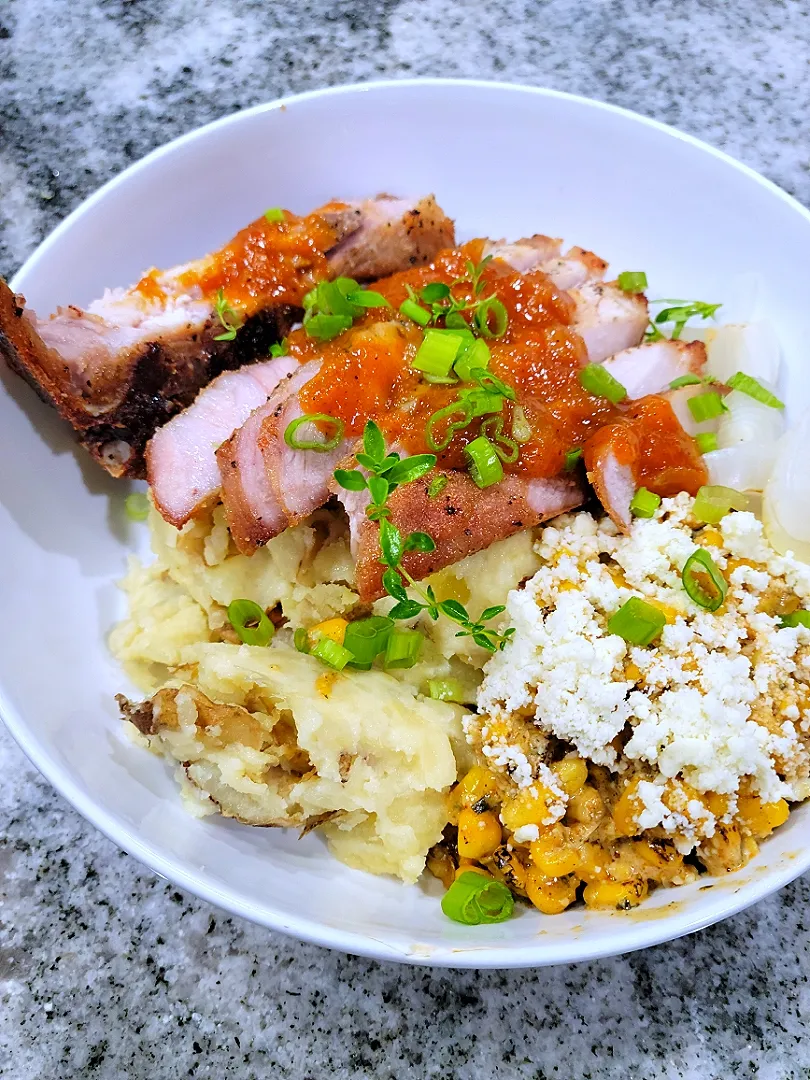 thick cut pork chops smashed potatoes and elote.|justinさん