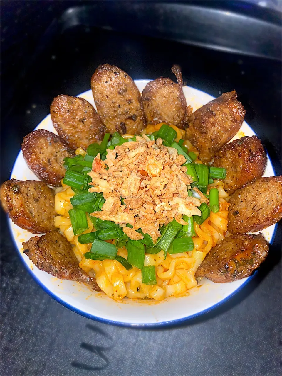 BentoFox's dish Spicy Korean noodles, and German sausage topped with scallions and fried onion bits 🤤|BentoFoxさん