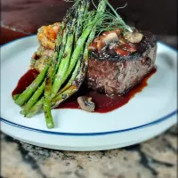 Snapdishの料理写真:8oz Prime filet topped with sauteed mushrooms and a cabernet port demi glace served along side a stack of fried polenta cakes with pistachio pesto and tomato ba|Matt Burleighさん