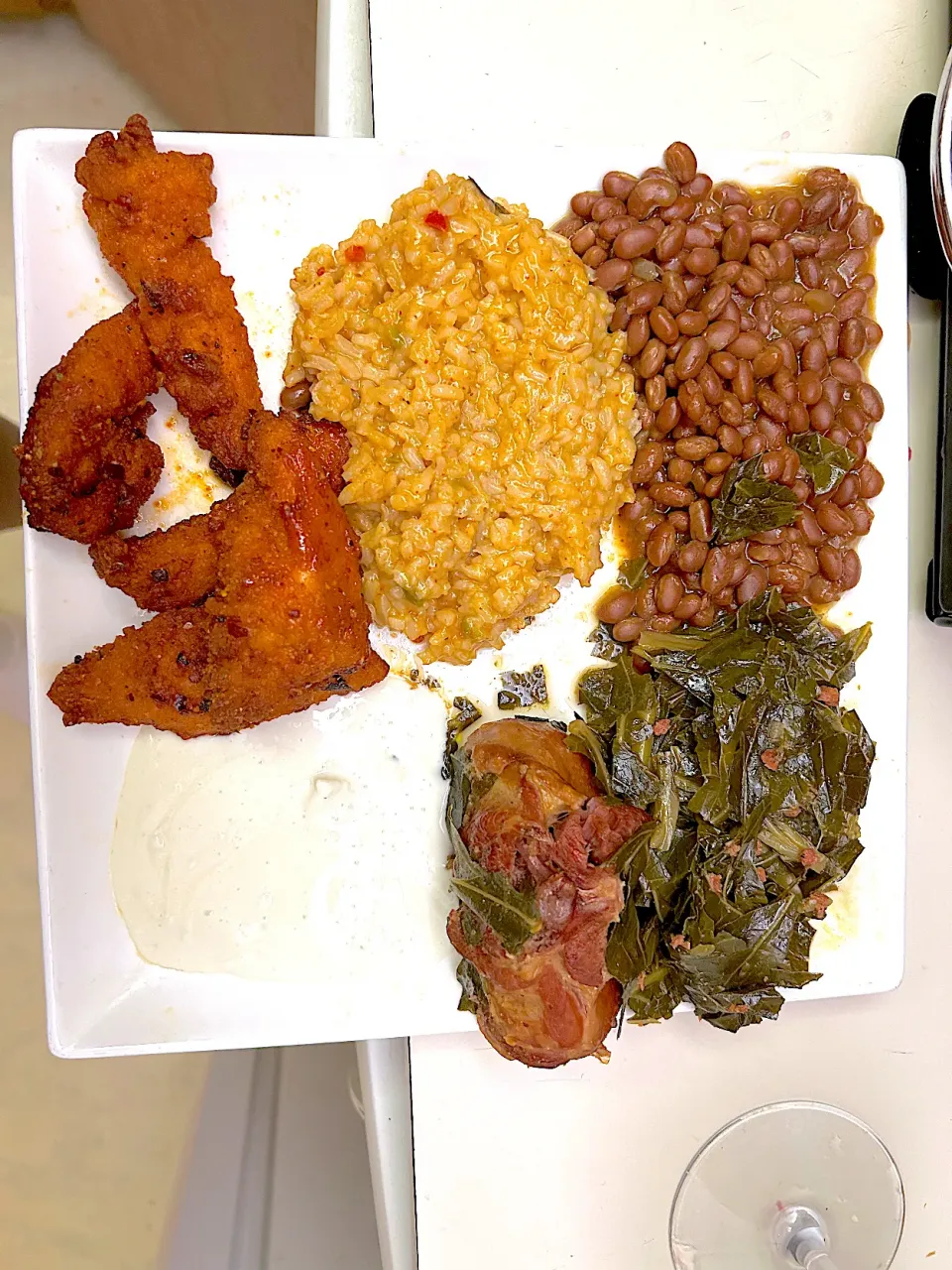 Spicy chicken strips with homemade sauce with collard greens with jambalaya rice and  vegetarian beans with blue cheese sauce |Kareem Boogieさん