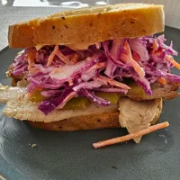 pork belly sandwich w/ dijonmayo, pickled cucumber and red cabbage slaw.